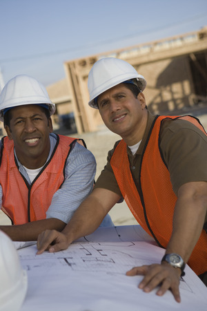 Two architects looking at blueprintsの写真素材
