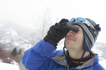 Skier Looking Through Binocularsの写真素材