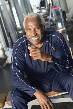 Senior Man Eating Healthy Snack at Gym