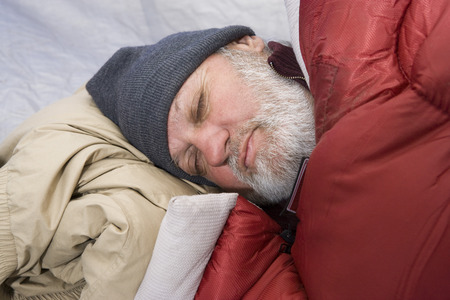 Senior man sleeping in a tentの写真素材