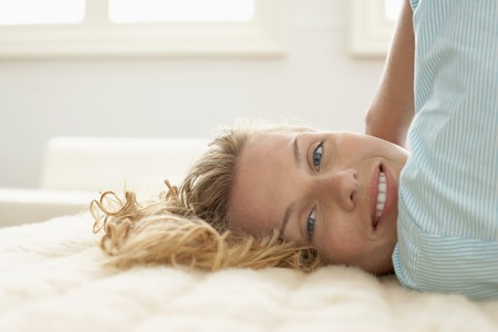 Woman Relaxing on Bedの写真素材