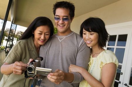 Family watching video on video camera