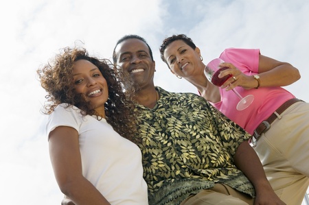 Couple with friend outdoors (portrait) (low angle view)の写真素材