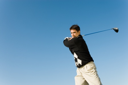 Golfer swinging club