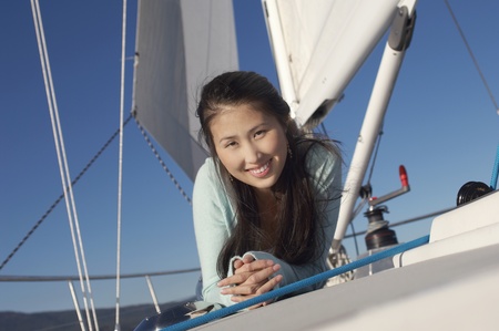Young woman on sailboat (portrait)の写真素材