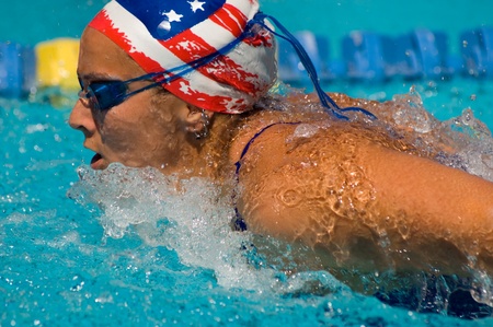 Woman swimming butterfly stroke (close-up)の写真素材