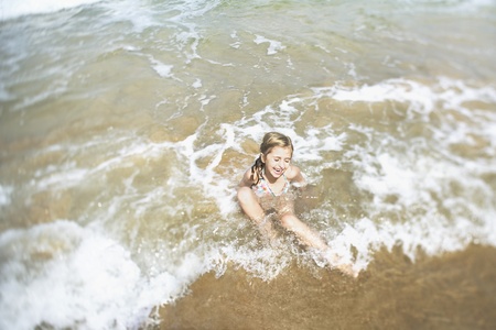 Girl playing in surf elevated viewの写真素材