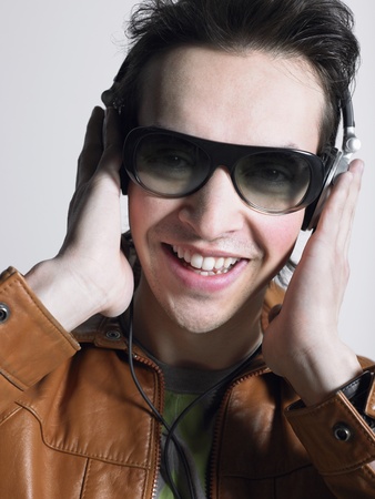 Man wearing headphones and sunglasses head and shouldersの写真素材