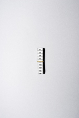 Roll of measuring tape with rubber band view from aboveの写真素材