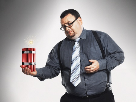 Businessman holding sticks of dynamiteの写真素材