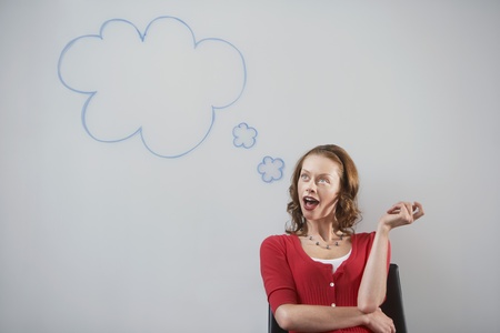 Woman sitting in front of graphic on whiteboard