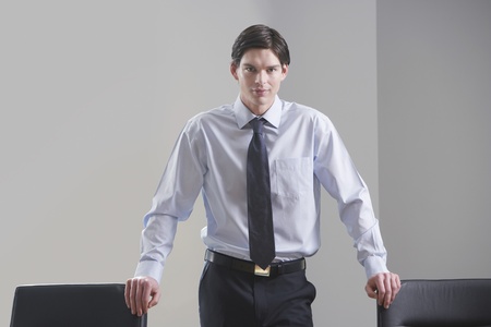 Businessman standing in conference room portraitの写真素材