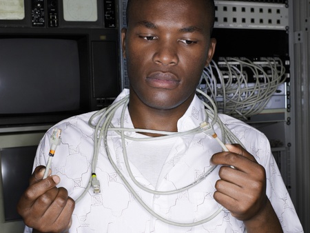 Young man with network cables around neck front view.