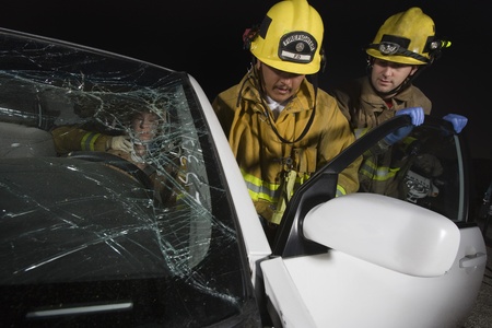 Firefighters rescuing car accident victim