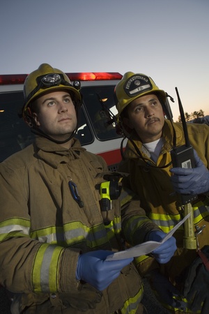 Firefighters planning rescue by fire engine