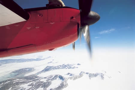Plane Flying over Snowy Landscape cropped