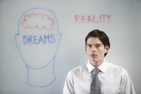 Businessman in front of graphic on whiteboard