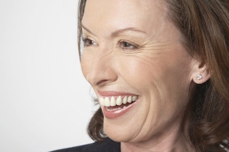 Middle-aged woman smiling big side view close-up