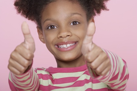 Young Girl smiling Giving Thumbs Up
