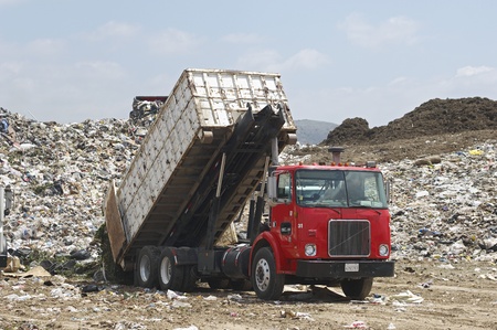 Truck dumping waste at landfill siteの写真素材