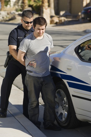 Police Officer Arresting Young Manの写真素材