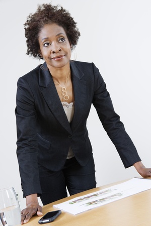 Businesswoman Leaning on Tableの写真素材