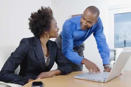 Businesspeople Using Laptop During Meetingの写真素材