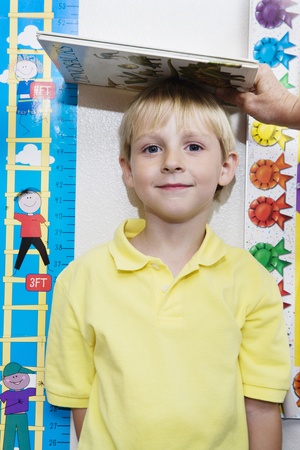 Boy Getting Height Measuredの写真素材