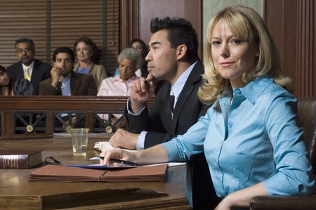 Defense lawyer with client in courtの写真素材