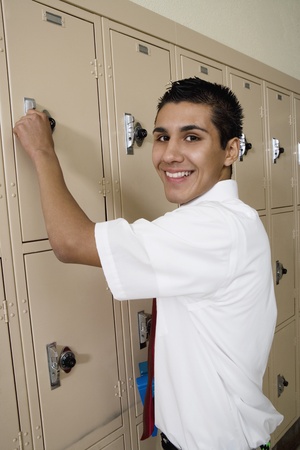 High School Boy Opening Lockerの写真素材