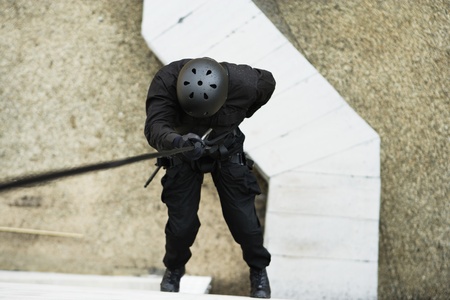 SWAT Team Officer Rappelling from Buildingの写真素材