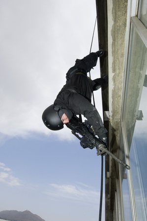 SWAT Team Officer Rappelling from Buildingの写真素材