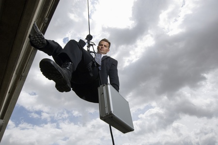 Spy Rappelling with Suitcaseの写真素材