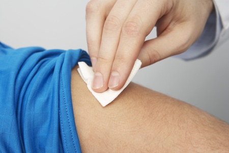 Disinfecting patient's armの写真素材