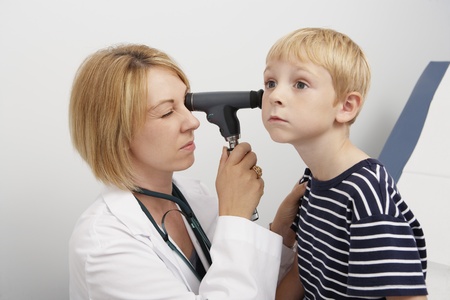 Female doctor examining boyの写真素材