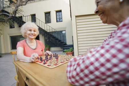 Two senior men playing chessの写真素材