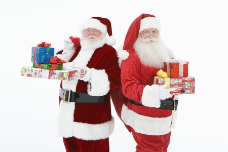 Two men dressed as Santa Claus holding giftsの写真素材