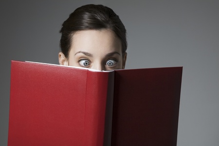 Cross-eyed Brunette and red book coverの写真素材