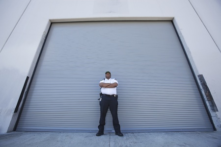 Security guard protects warehouse entranceの写真素材