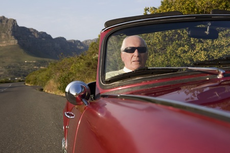 Senior man in vintage racing car on Signal Hill  Cape Town  South Africa