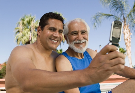 Senior Father and Son Taking Picture on Cell Phoneの写真素材