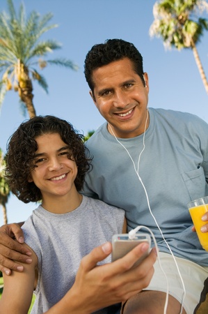 Father and Son Listening to MP3 Playerの写真素材
