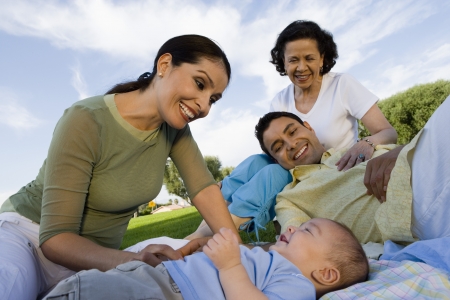 Family with baby (6-12 months) relaxing outdoors
