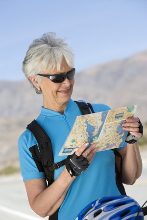 Senior woman reading mapの写真素材