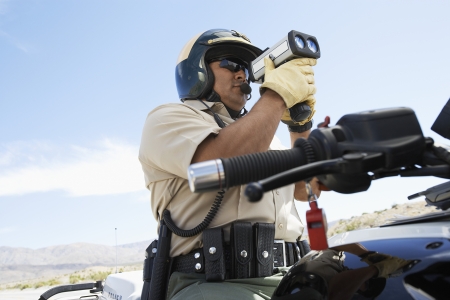 Police Officer Holding Radar Gun