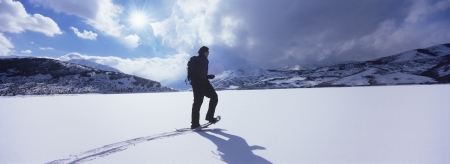 Man Hiking Through Snowの写真素材