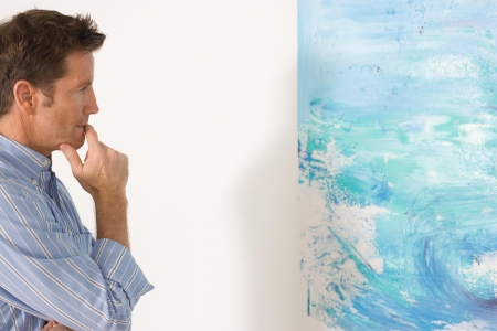 Man contemplating paintings in gallery