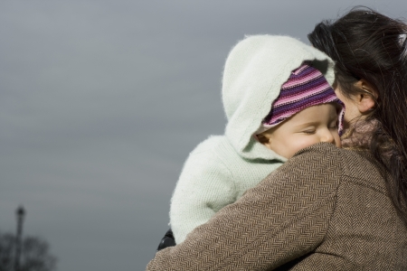 Mother with baby sleeping in her armsの写真素材