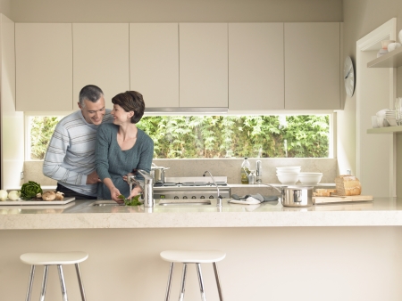 Smiling couple in kitchenの写真素材
