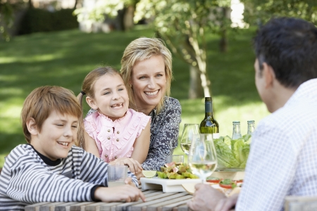 Family Enjoying a Meal Outdoorsの写真素材